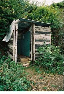 Photo of dilapidated latrine for 400 students and staff.