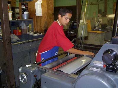Student working at the Johnston High School Print Shop.