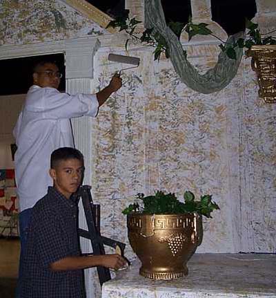 Students adjusting the set of 'On the Way to the Forum'